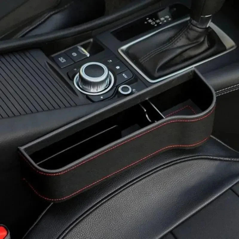 Close-up of a car's center console with gear shift and control buttons.