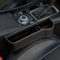 Close-up of a car's center console with gear shift and control buttons.