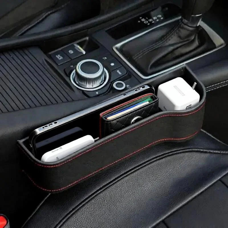 Car console organizer with phone, remote, and other items inside a vehicle.